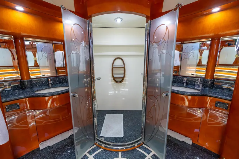 Kaya Yacht Photos Pics Luxurious yacht bathroom with dual sinks, glass shower, and elegant wood cabinetry, Johnson 87, 2003 model.