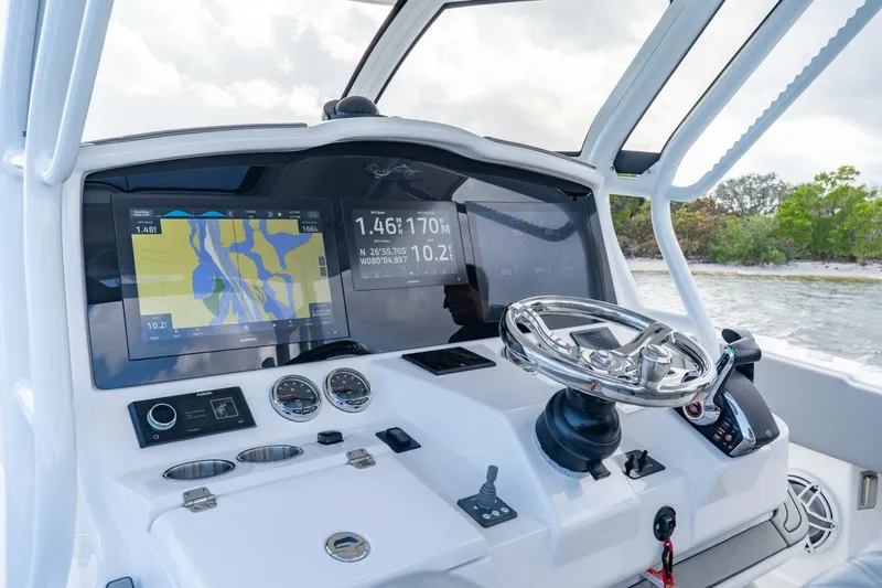 Bramate Yacht Photos Pics 2023 Blackwater High-Performance boat dashboard with navigation screens and steering wheel.