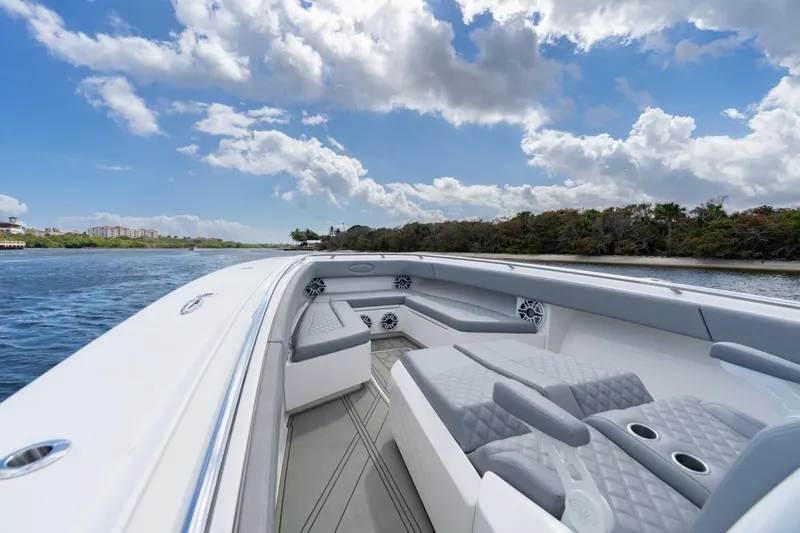 Bramate Yacht Photos Pics 2023 Blackwater High-Performance boat interior with luxurious seating on a scenic waterway.