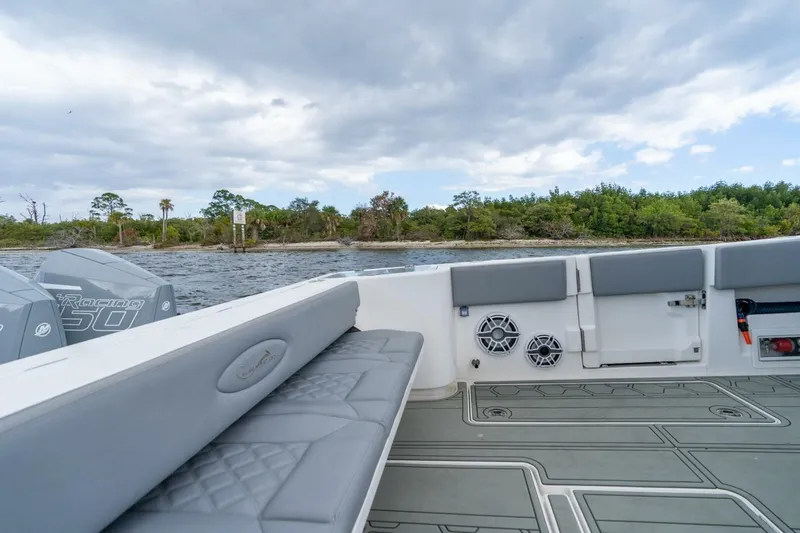 Bramate Yacht Photos Pics 2023 Blackwater High-Performance boat interior with seating, speakers, and scenic water view.