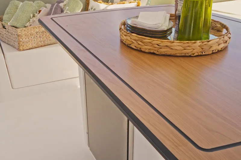 Stills Yacht Photos Pics Modern Bali 5.2 yacht interior with wooden table, wicker basket, and elegant decor, 2026 model.