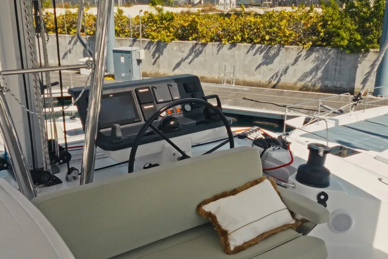 Stills Yacht Photos Pics 2026 Bali 5.2 yacht cockpit with steering wheel and cushioned seating.