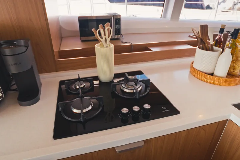 Stills Yacht Photos Pics Modern kitchen in 2026 Bali 5.2 yacht with stove, coffee maker, and utensils.