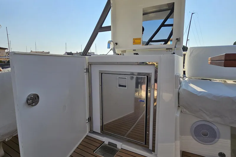 Shadow Yacht Photos Pics 2024 Prestige F4 yacht with open storage compartment and sleek interior design.