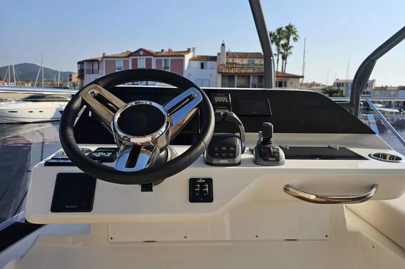 Shadow Yacht Photos Pics 2024 Prestige F4 yacht helm with modern controls and steering wheel, docked at marina.