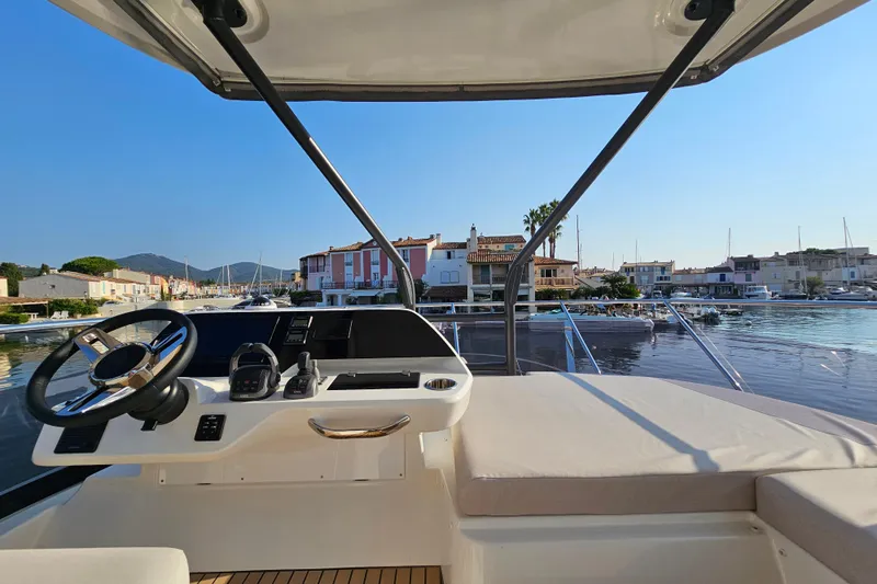 Shadow Yacht Photos Pics 2024 Prestige F4 yacht helm with waterfront view, featuring modern controls and comfortable seating.