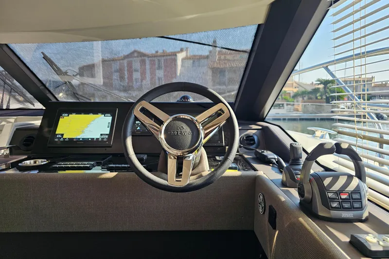Shadow Yacht Photos Pics Cockpit of 2024 Prestige F4 yacht with steering wheel and navigation system.