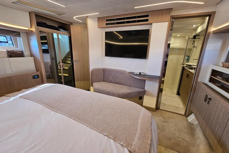 Shadow Yacht Photos Pics Luxurious 2024 Prestige F4 yacht interior with modern bedroom, TV, and ensuite bathroom.
