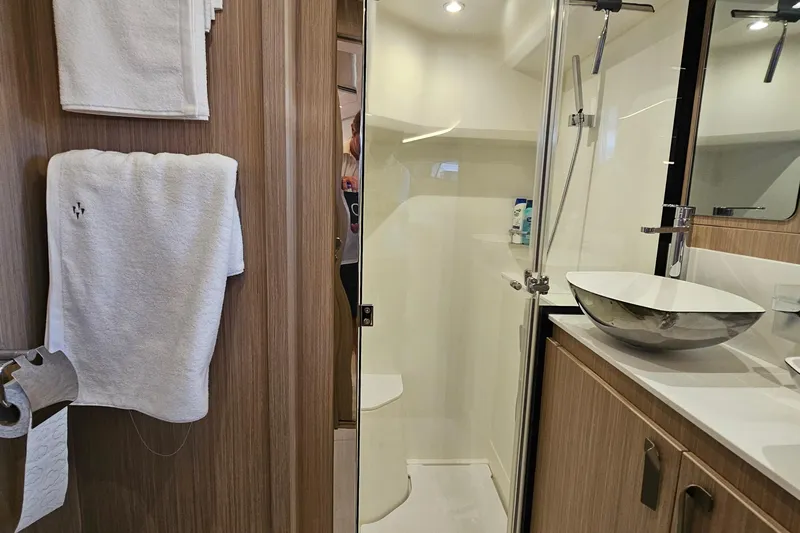 Shadow Yacht Photos Pics Modern bathroom in 2024 Prestige F4 yacht with sleek fixtures and wooden accents.