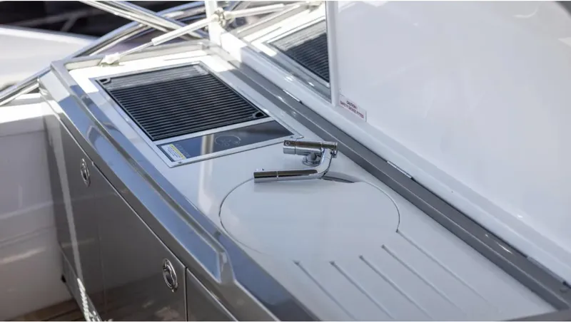  Yacht Photos Pics Outdoor kitchen area on 2022 Princess S66 yacht with grill and sink.