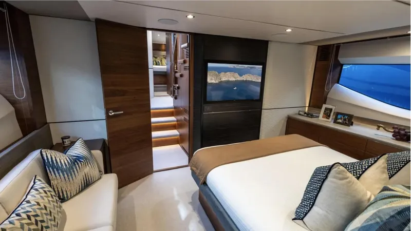  Yacht Photos Pics Luxurious 2022 Princess S66 yacht bedroom with modern decor and scenic window view.
