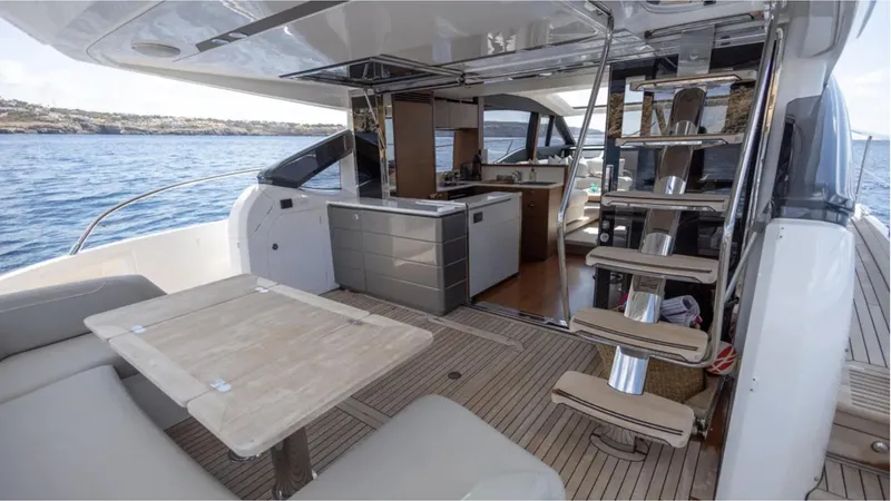  Yacht Photos Pics Luxurious 2022 Princess S66 yacht interior with modern kitchen and seating area.