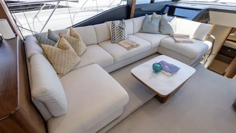  Yacht Photos Pics Luxurious interior of 2022 Princess S66 yacht with elegant white sofa and cushions.
