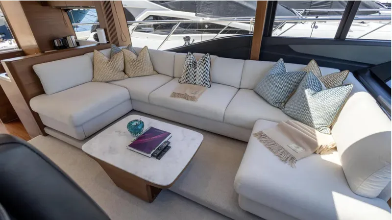  Yacht Photos Pics Luxurious interior of 2022 Princess S66 yacht with elegant white sofa and decorative pillows.