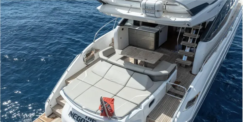  Yacht Photos Pics Luxurious 2022 Princess S66 yacht with spacious deck and seating area on open sea.