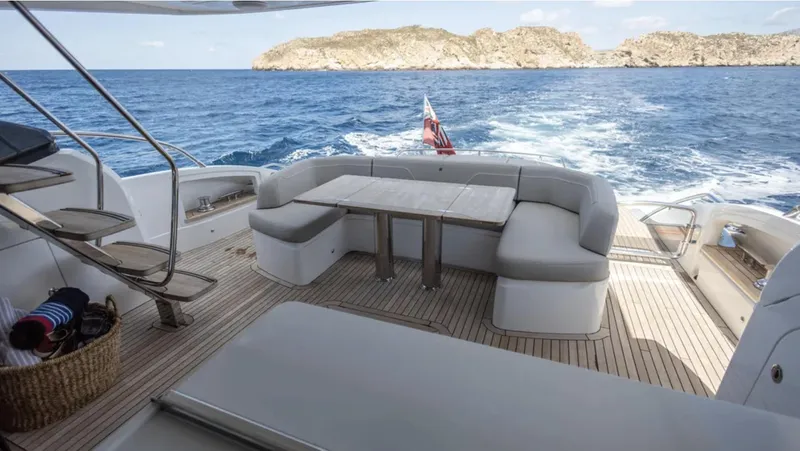  Yacht Photos Pics Luxurious 2022 Princess S66 yacht deck with seating, cruising on open sea.