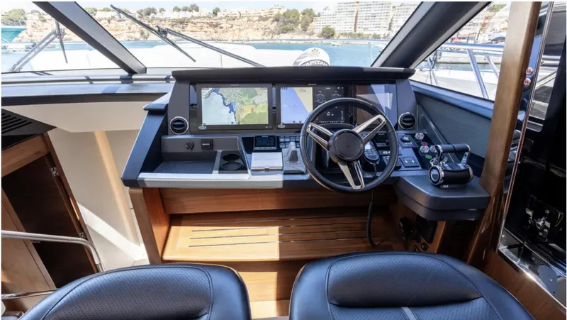  Yacht Photos Pics Helm of 2022 Princess S66 yacht with modern navigation equipment and leather seating.