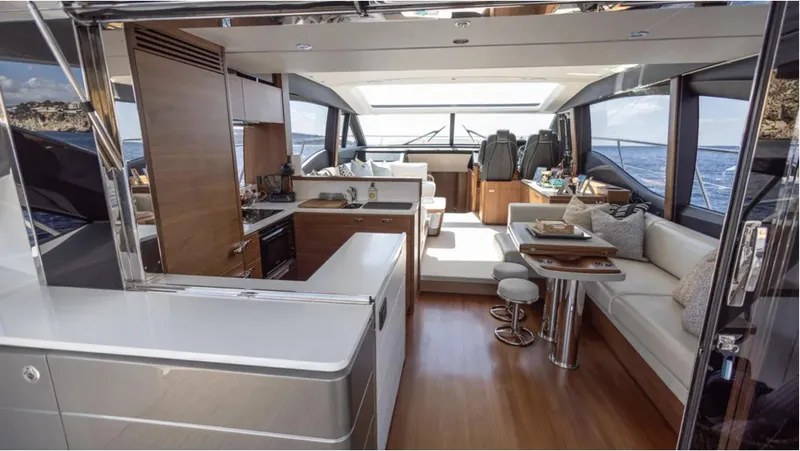  Yacht Photos Pics Luxurious interior of 2022 Princess S66 yacht with modern kitchen and seating area.