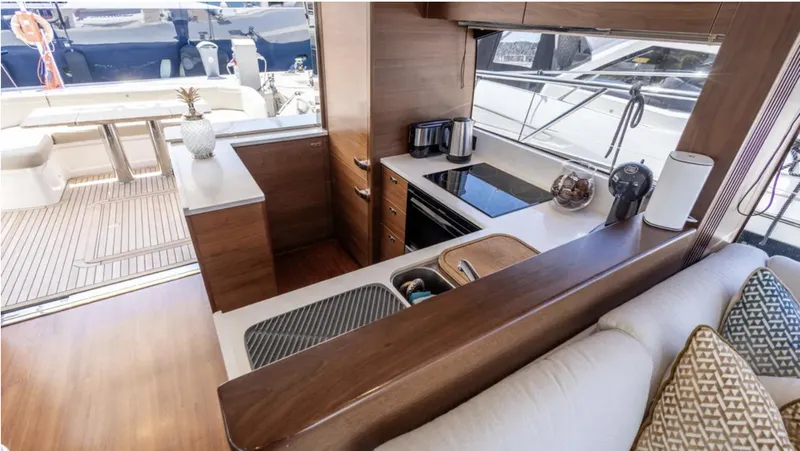  Yacht Photos Pics Luxurious 2022 Princess S66 yacht interior with modern kitchen and elegant wood finishes.