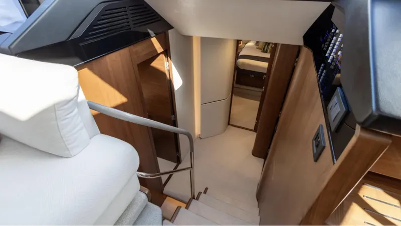 Yacht Photos Pics Interior view of 2022 Princess S66 yacht, featuring elegant wooden stairs and modern design.
