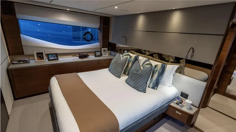  Yacht Photos Pics Luxurious bedroom interior of 2022 Princess S66 yacht with elegant decor and ocean view.
