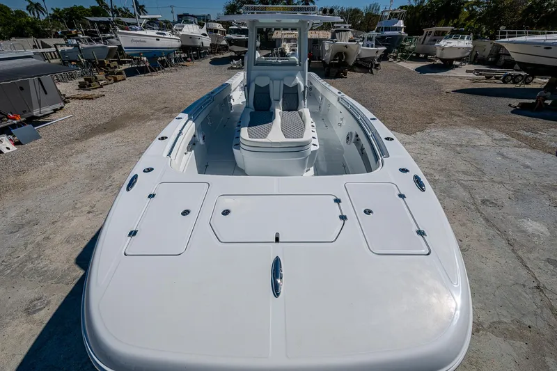  Yacht Photos Pics 2025 Invincible 33 Catamaran in a boatyard, showcasing sleek design and spacious deck.