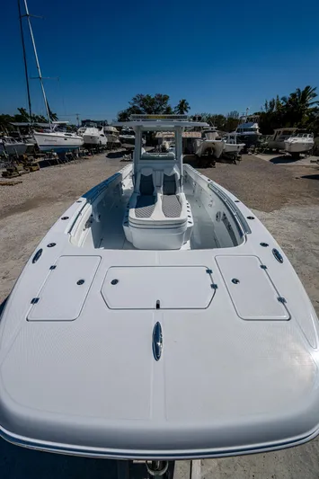  Yacht Photos Pics 2025 Invincible 33 Catamaran, sleek design, docked under clear blue sky.