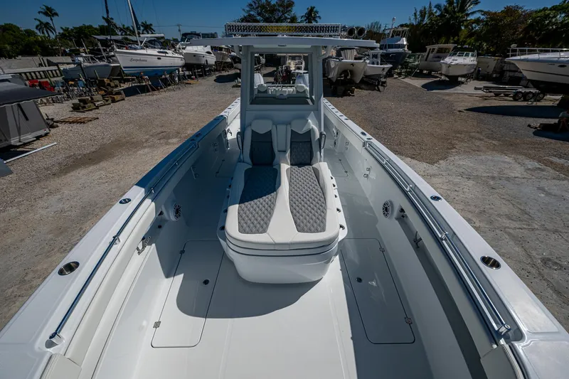  Yacht Photos Pics 2025 Invincible 33 Catamaran with spacious deck and seating, docked in a marina.