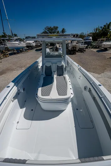  Yacht Photos Pics 2025 Invincible 33 Catamaran with sleek design and spacious deck in a sunny marina.