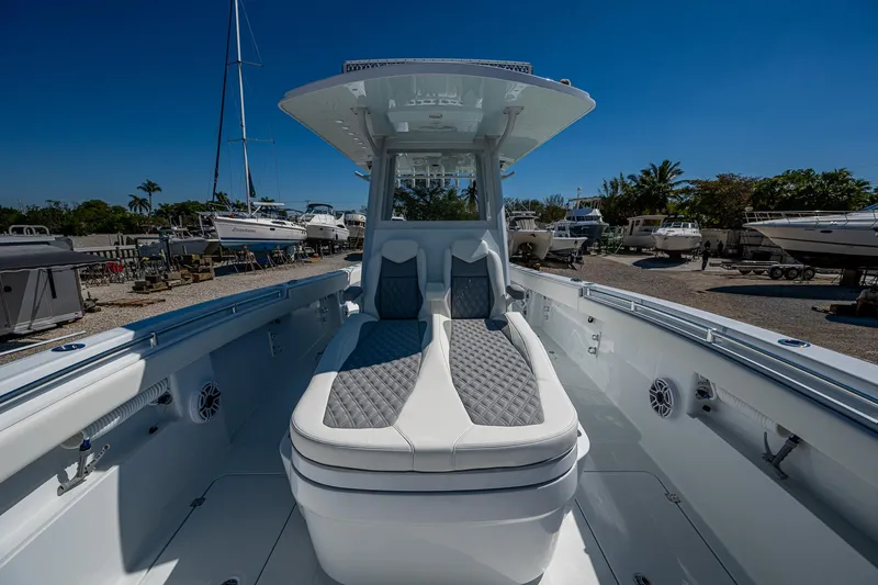  Yacht Photos Pics 2025 Invincible 33 Catamaran with sleek seating, docked under clear blue sky.