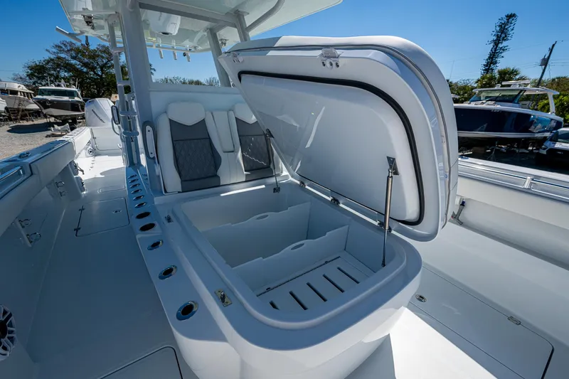  Yacht Photos Pics 2025 Invincible 33 Catamaran with open storage compartment and seating, showcasing modern design.