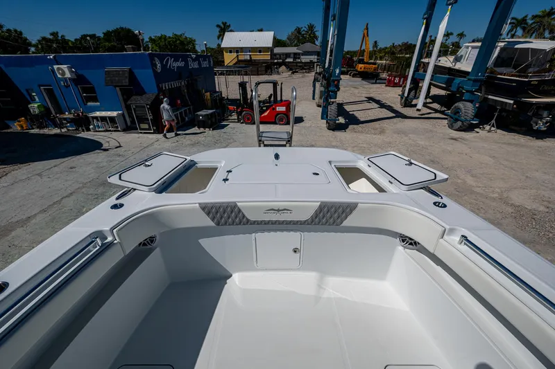  Yacht Photos Pics 2025 Invincible 33 Catamaran at dock, showcasing spacious deck and storage compartments.