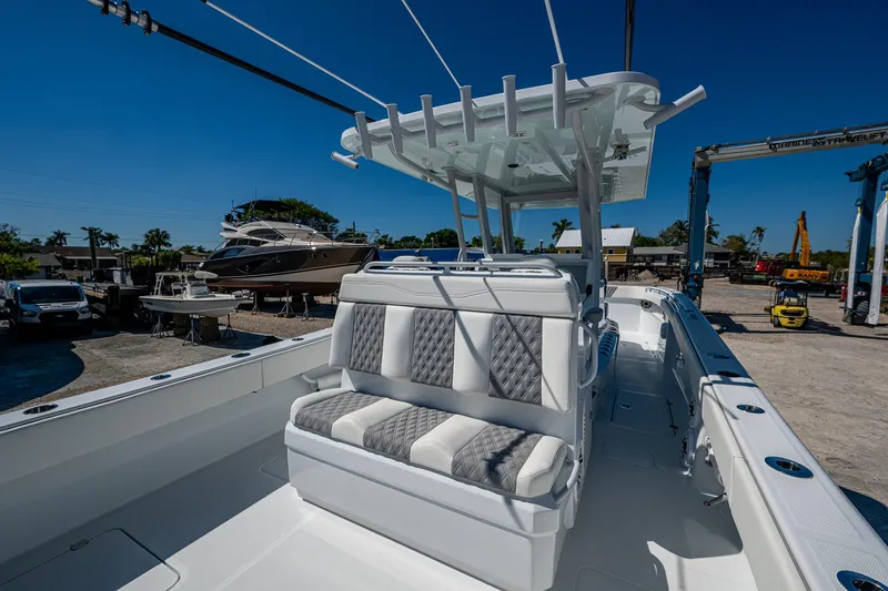  Yacht Photos Pics 2025 Invincible 33 Catamaran with cushioned seating and sleek design in a marina setting.