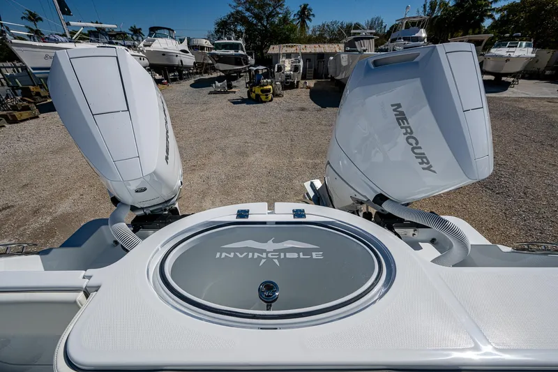  Yacht Photos Pics 2025 Invincible 33 Catamaran with dual Mercury outboard engines in a boatyard.