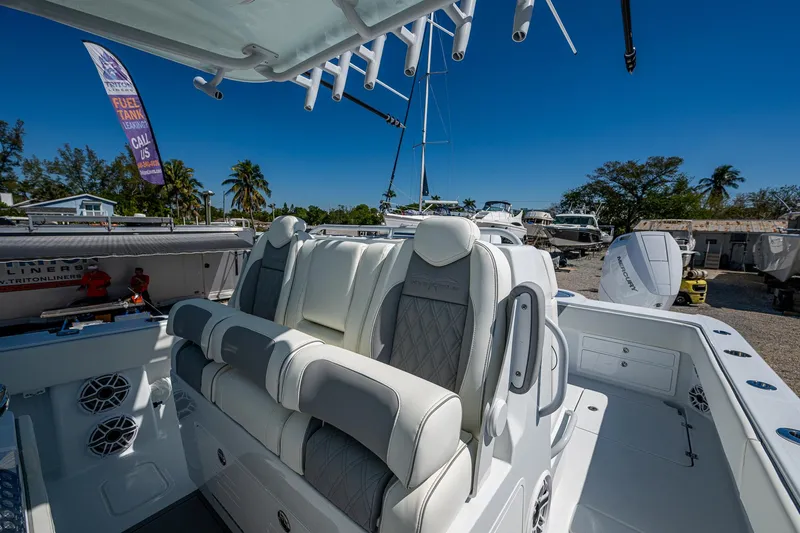  Yacht Photos Pics 2025 Invincible 33 Catamaran with luxurious seating, docked under clear blue skies.