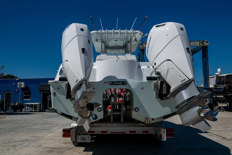  Yacht Photos Pics 2025 Invincible 33 Catamaran with dual outboard engines on a trailer, under clear blue sky.