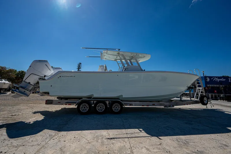  Yacht Photos Pics 2025 Invincible 33 Catamaran on trailer under clear blue sky.