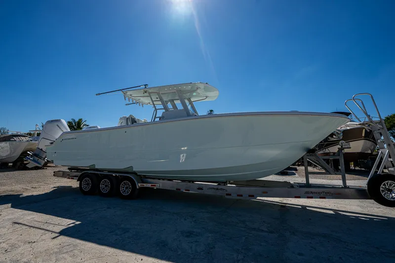  Yacht Photos Pics 2025 Invincible 33 Catamaran on trailer under clear blue sky.