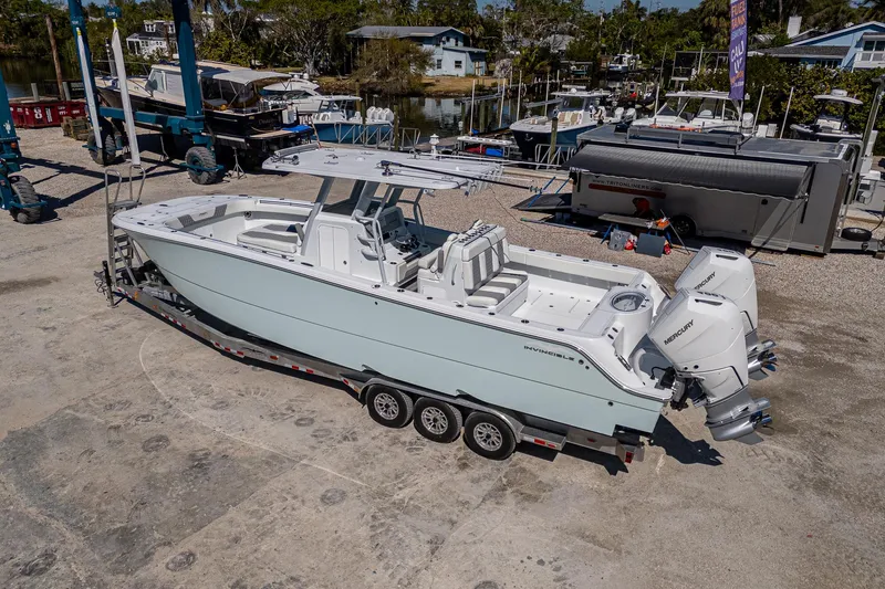  Yacht Photos Pics 2025 Invincible 33 Catamaran on trailer, dockside, with dual outboard engines.