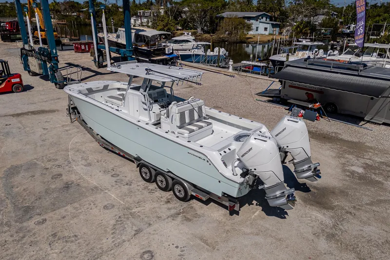  Yacht Photos Pics 2025 Invincible 33 Catamaran on trailer, dockside, with twin outboard engines.