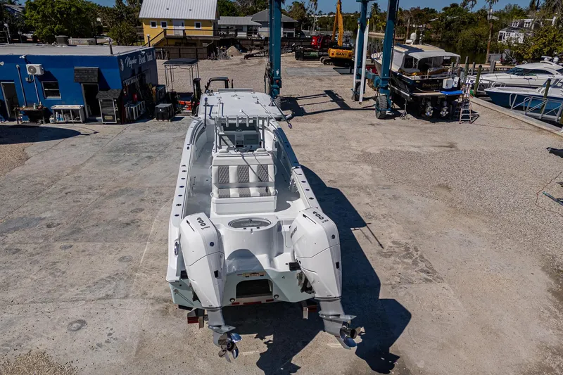  Yacht Photos Pics 2025 Invincible 33 Catamaran on dry dock, showcasing sleek design and twin engines.