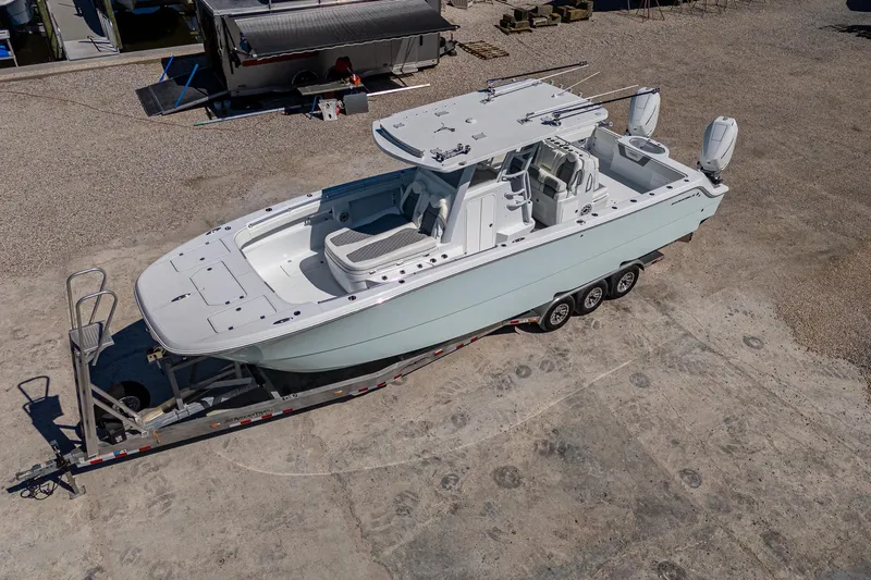  Yacht Photos Pics 2025 Invincible 33 Catamaran on trailer, aerial view, parked on concrete surface.