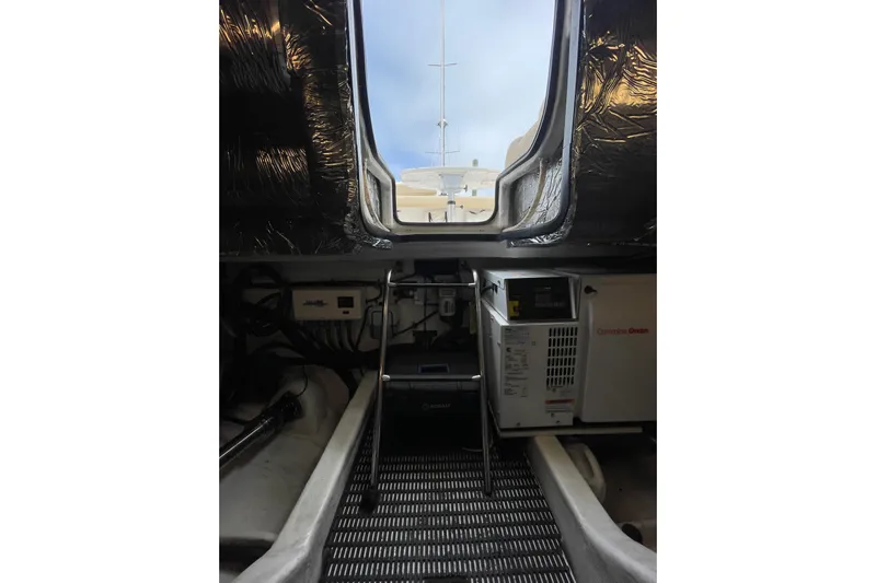 Sasea Yacht Photos Pics Engine room of 2009 Tiara Yachts 4200 Open, featuring equipment and access ladder.
