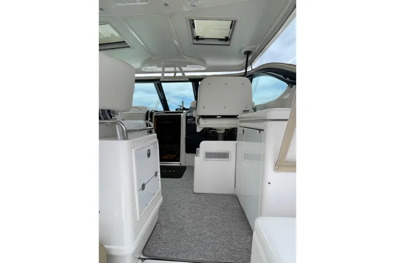 Sasea Yacht Photos Pics Interior view of 2009 Tiara Yachts 4200 Open, featuring helm and seating area.