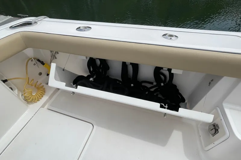 Sasea Yacht Photos Pics Storage compartment on a 2009 Tiara Yachts 4200 Open, featuring coiled hose and black ropes.