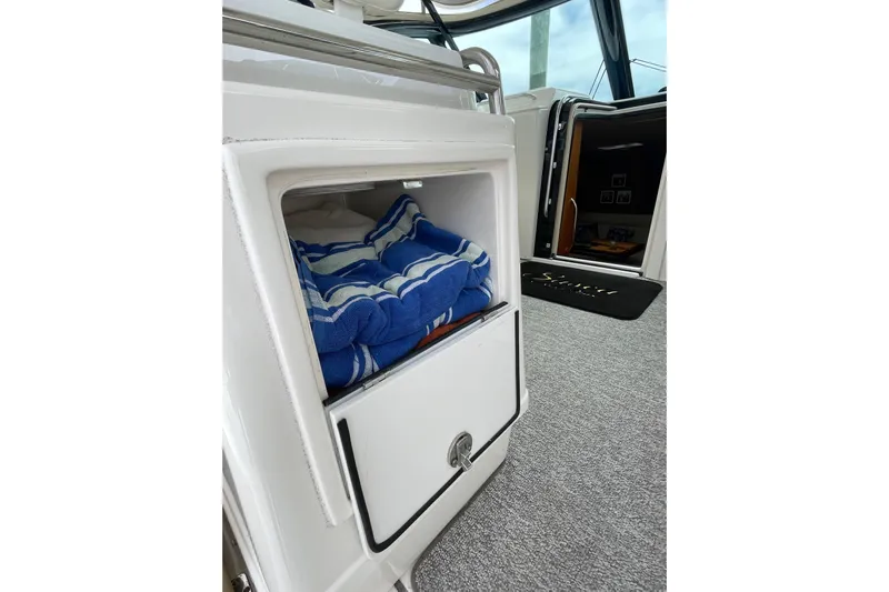Sasea Yacht Photos Pics Storage compartment with blue striped towels on a 2009 Tiara Yachts 4200 Open.