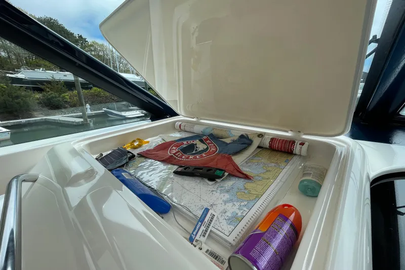 Sasea Yacht Photos Pics Storage compartment on 2009 Tiara Yachts 4200 Open with maps and boating essentials.