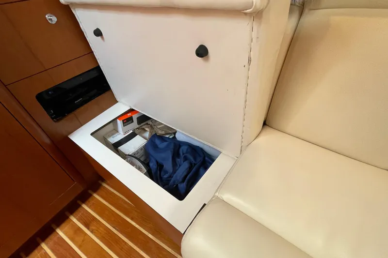 Sasea Yacht Photos Pics Storage compartment under seat in 2009 Tiara Yachts 4200 Open, featuring wooden flooring.