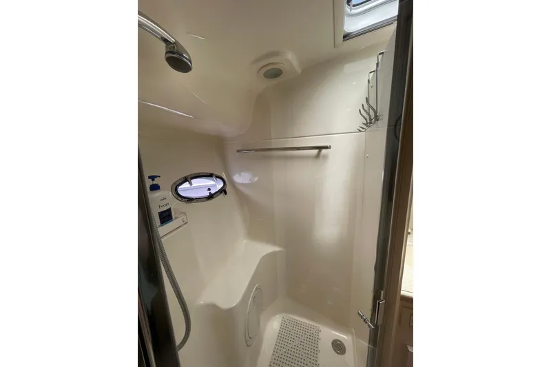 Sasea Yacht Photos Pics Shower area in 2009 Tiara Yachts 4200 Open, featuring modern fixtures and porthole window.