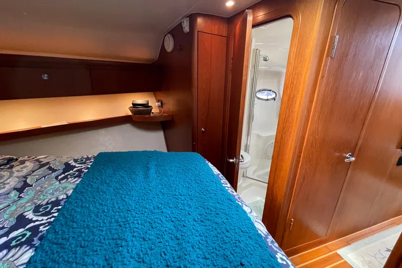 Sasea Yacht Photos Pics Luxurious 2009 Tiara Yachts 4200 Open cabin interior with wood finish and private bathroom.